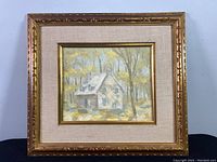 Full view of framed oil on canvas painting showing house and trees in autumn colors.