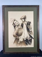 Framed charcoal drawing capturing a happy couple in Jewish traditional clothing, signed Yakov M.