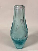 Front view of the blue glass vase showing etched cranes and Chinese seal marks.