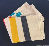 Folded view of the wool blanket showing colorful stripes and texture
