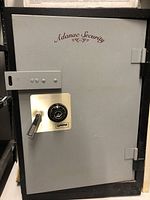 Front view of closed safe showing Adanac Security logo, combination dial and handle