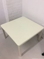 Top view showing the smooth grey surface and rounded edges of the square side table.