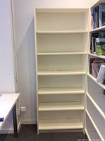 Front view of the white 6-tier bookshelf showing all shelving units empty, clean simple design.
