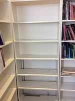 Front view of white 6-tier bookshelf with empty shelves, showing 5 full shelves plus modified bottom shelf.