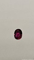 Close-up image of natural untreated red ruby gemstone on neutral background