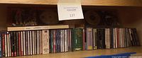 Wide view of classical CD collection in cases and box sets arranged on a shelf; CDs include various classical titles and series.