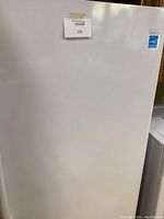 Closed front view showing door, lot label, white finish