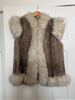 Front view of vintage fur vest showing textured brown fur with cream fur trim