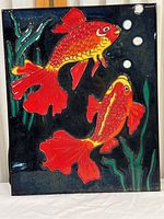 Full view of rectangular glazed ceramic tile with two koi fish and aquatic plants on dark blue background.