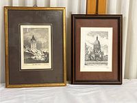 Pair of two framed pencil drawing prints showing architectural scenes, side by side.