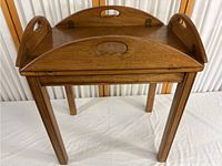 Solid wood Brandt butler tray table with removable tray and foldable sides shown from side angle.