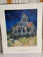 Full view of the framed Vincent Van Gogh print of a church with the artist's name under the image.