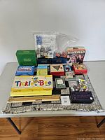 Full view of all assorted games and pieces arranged on table showing colorful boxed games and loose components