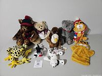 Photo of the entire assortment of stuffed animals including frogs, bears, dog, Garfield puppet, Sylvester, and Dalmatian plush toys.