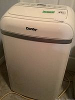 Front view of Danby white dehumidifier with grey trim, brand visible.