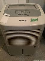 Front view of Danby dehumidifier with vents and Danby logo visible, showing overall shape, size and condition.