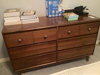 Front view of Vilas dresser showing six drawers and metal knobs; items placed on top for size reference.
