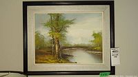 Framed landscape acrylic painting showing river, trees, and mountains, signed by artist.