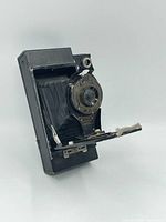 Full view of the Eastman Kodak folding camera showing bellows extended and metal folding body.