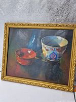 Full view of the antique oil painting featuring three vases on a dark surface in a gold frame