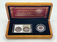 Wooden box opened showing the 50 cent coin in capsule and two commemorative stamps inside, with gold embossed text on lid.