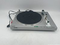 Front left angle of the SONY turntable showing power cords and general wear.