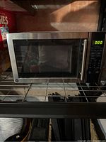 Front view of the General Electric microwave oven showing stainless steel finish and digital control panel.
