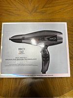 Photo of the Infiniti Pro hair dryer box showing product image, branding, and features