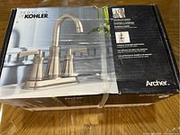 Photo of the Kohler Archer faucet box showing the faucet image and branding on the front.