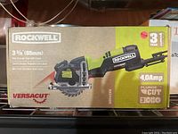Photo of the product box showing Rockwell branding, model RK3440K, 3-3/8 inch blade size, 4.0 Amp motor, laser guide, and 3-year warranty.