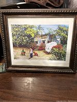 Framed painting depicting a West Indies scene with tropical vegetation, people, and a small dog near a house