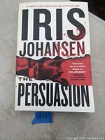 Front cover of paperback book 'The Persuasion' by Iris Johansen showing title and author with graphic design.