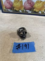 Front view of the skull ring showing detailed skull face and helmet design.