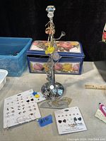 Overview of the lot showing a silver metal earring tree with various earrings hanging and multiple cards of pierced earrings alongside.