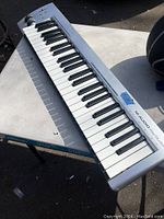 Full view of the M-Audio KeyStudio MIDI keyboard showing the 49 piano-style keys and control panel.