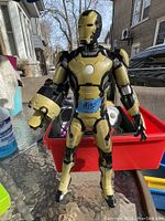 Clear photo of a 15-inch tall talking Ironman figurine in gold and black armor, standing upright with a weapon arm attachment.