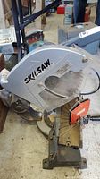 Close-up of the saw blade guard with Skilsaw branding and part of the adjustment scale visible