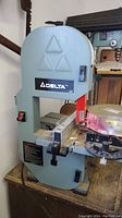Full front view of Delta band saw on workbench
