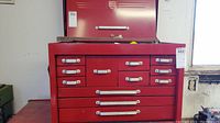 Front view of red Mastercraft top tool chest with hinged lid closed and Mastercraft badge visible