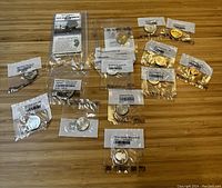 Overview of all individual pouches and display card on wood surface