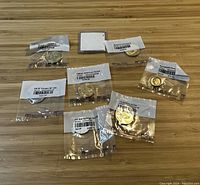 Overhead view of six sealed coin bags and a blank coin flip