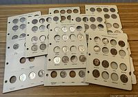 Overview of six album pages laid out on tabletop