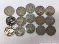 Top view of 15 US Jefferson nickels showing obverse and reverse sides with wear and toning.