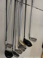 Golf irons shown side by side including 2 Tommy Armour 845s Silver Scot, other variety of irons with steel shafts and used condition.