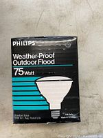 Box with Philips branding showing weather-proof outdoor flood 75 watt bulb with standard base and 2000 hours rated life