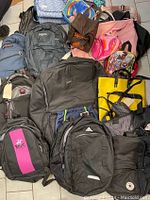 Overview of assorted bags and backpacks including various brands and colors