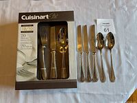 Five loose stainless steel cutlery pieces including forks, knives, and spoons, matching set with beaded edges.