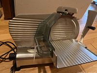 Front angle view showing blade, food carriage and power cord
