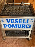 Rack overview showing Peavey mixer on top shelf, Peavey CS1000 amp below, patch cables and signage