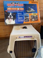 Photo showing Petmate Deluxe Vari Kennel plastic pet crate with original box behind it indicating suitability for pets up to 40 lbs